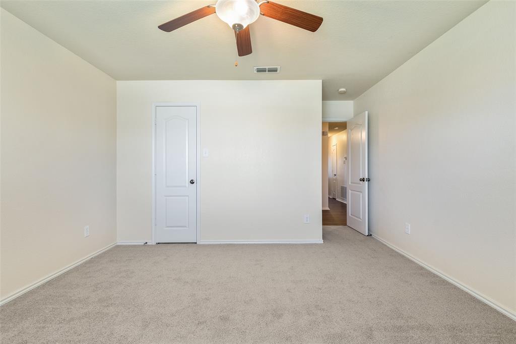 3917 Mantis Street Fort Worth, TX 76106 - Photo 17 of 22 an empty room with ceiling fan and window
