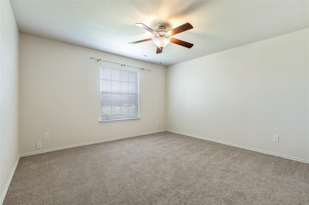 3917 Mantis Street Fort Worth, TX 76106 - Photo 18 of 22 an empty room with a window and a fan