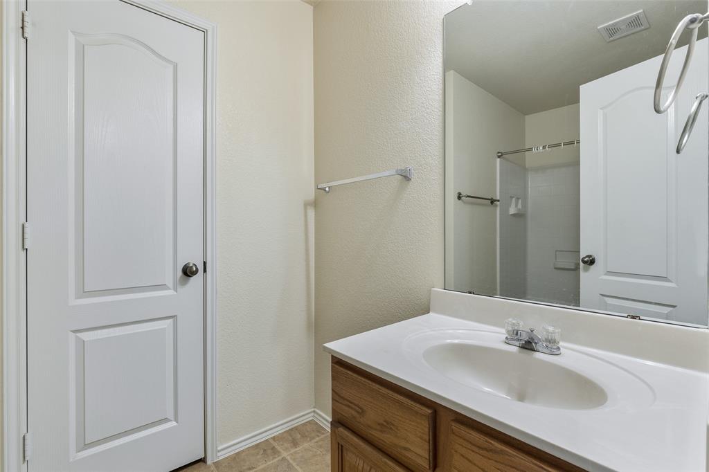 3917 Mantis Street Fort Worth, TX 76106 - Photo 20 of 22 a bathroom with a sink and a mirror