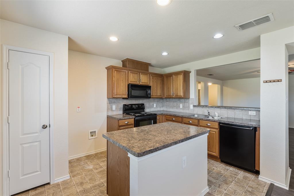 3917 Mantis Street Fort Worth, TX 76106 - Photo 2 of 22 a kitchen with a sink stove and refrigerator