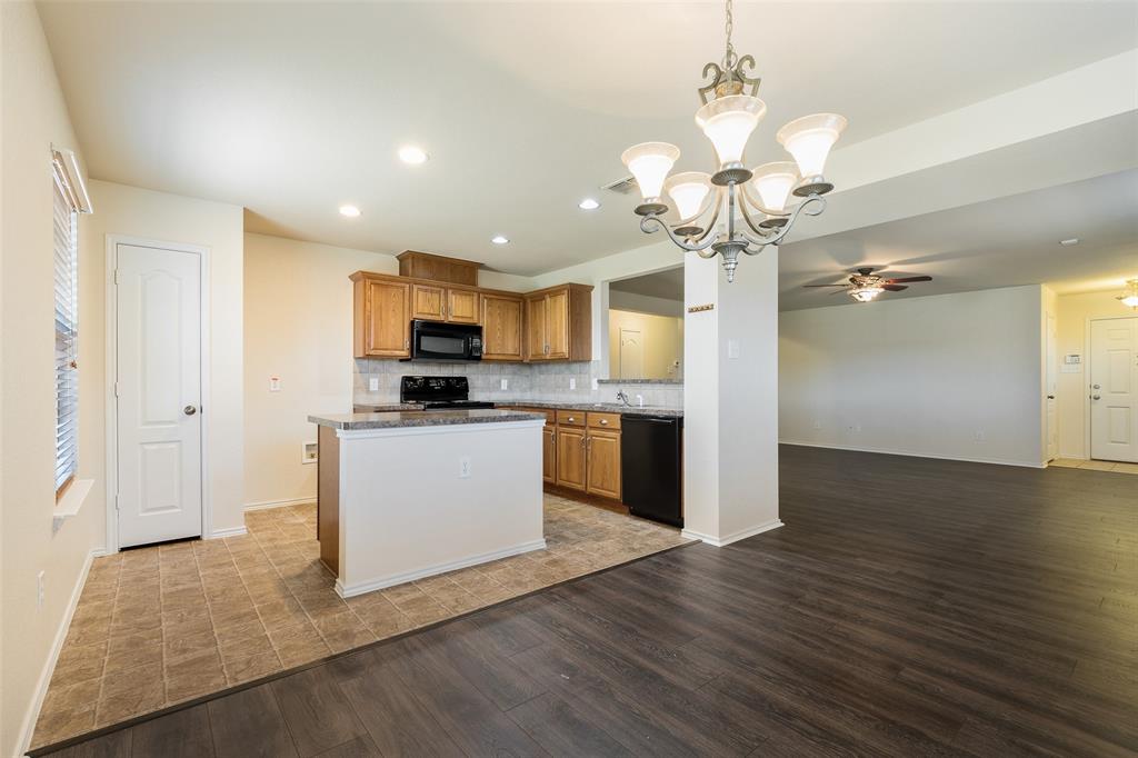 3917 Mantis Street Fort Worth, TX 76106 - Photo 4 of 22 a view of a kitchen with a sink a refrigerator and wooden floor