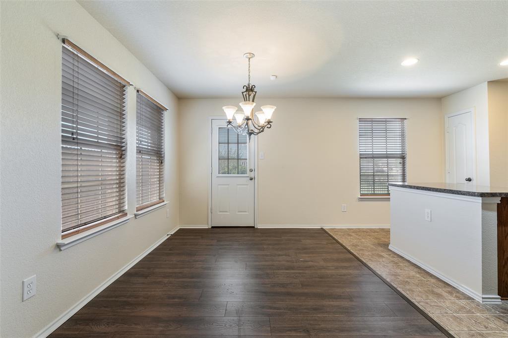 3917 Mantis Street Fort Worth, TX 76106 - Photo 5 of 22 a view of an empty room with wooden floor and a window
