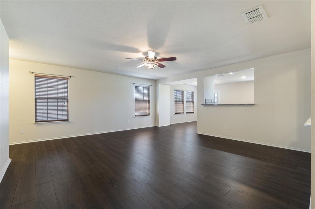 3917 Mantis Street Fort Worth, TX 76106 - Photo 7 of 22 a view of an empty room with wooden floor and a window