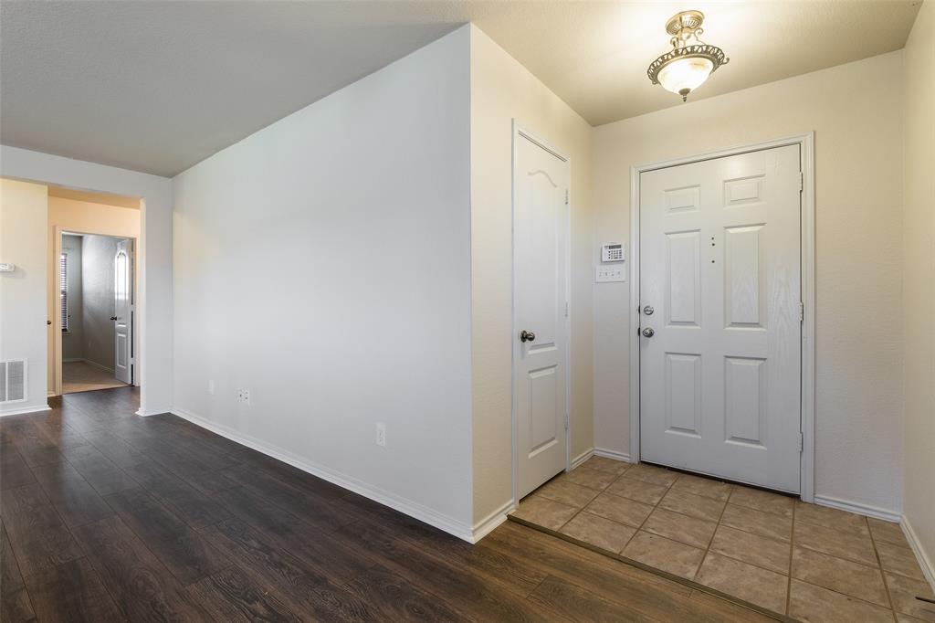 3917 Mantis Street Fort Worth, TX 76106 - Photo 9 of 22 a view of an empty room with wooden floor