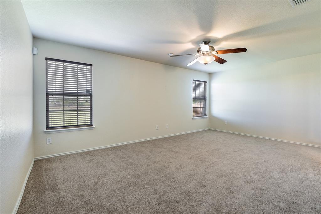 3917 Mantis Street Fort Worth, TX 76106 - Photo 10 of 22 an empty room with windows and fan