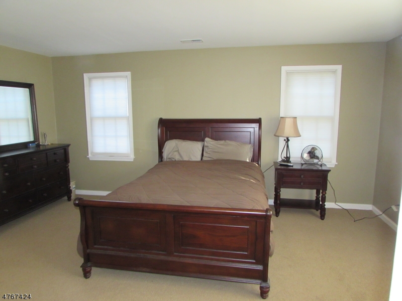 8 Genoble Road Montville, NJ 07045 - Photo 8 of 12 a bedroom with a bed and a window