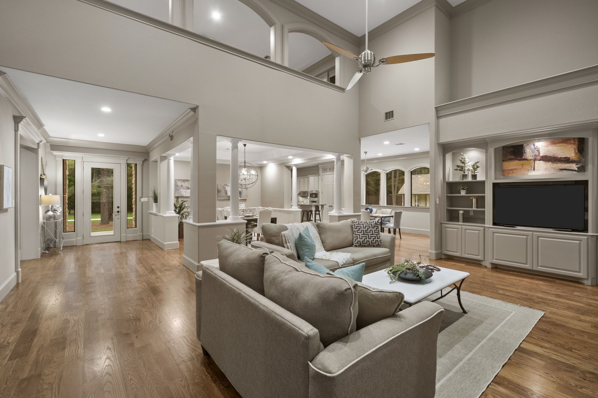 20010 Timber Ridge Drive Magnolia, TX 77355 - Photo 49 of 50 The open-floor plan creates a seamless flow between the entry and living spaces, perfect for entertaining. The hardwood floors, neutral tones, soaring ceilings, and modern ceiling fan create a warm and inviting atmosphere.