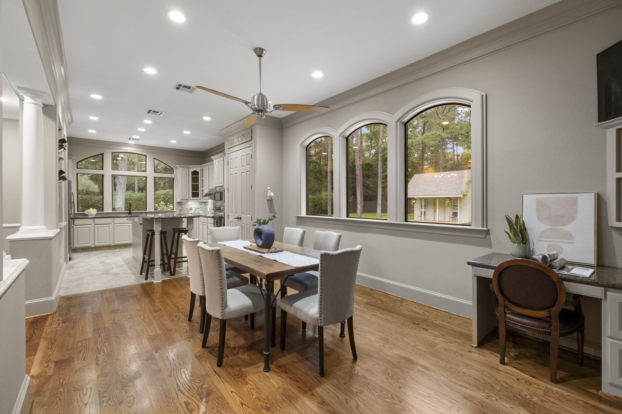 20010 Timber Ridge Drive Magnolia, TX 77355 - Photo 13 of 50 Hardwood floors and recessed lighting flow through this breakfast room and kitchen. Large windows provide natural light and scenic views of the greenery outside. A built-in desk space provides the perfect place for finishing the kids' homework or taking care of the family business.
