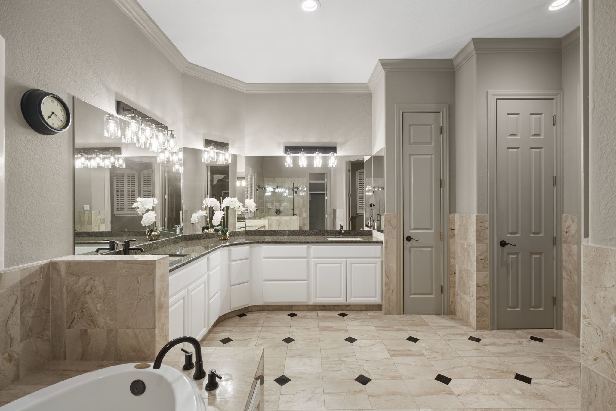 20010 Timber Ridge Drive Magnolia, TX 77355 - Photo 22 of 50 A double-sink vanity stretches across generous countertop space, perfect for busy mornings or relaxed evening routines, while expansive mirrors enhance the light and create an airy, open feel. A linen closet provides abundant storage and organization, and the separate water closet provides privacy.