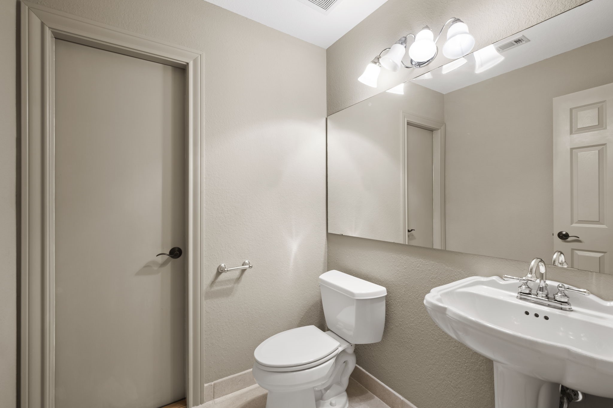 20010 Timber Ridge Drive Magnolia, TX 77355 - Photo 30 of 50 This clean, well-lit upstairs half bath features a pedestal sink, large mirror, and modern light fixture, creating a spacious and functional atmosphere.