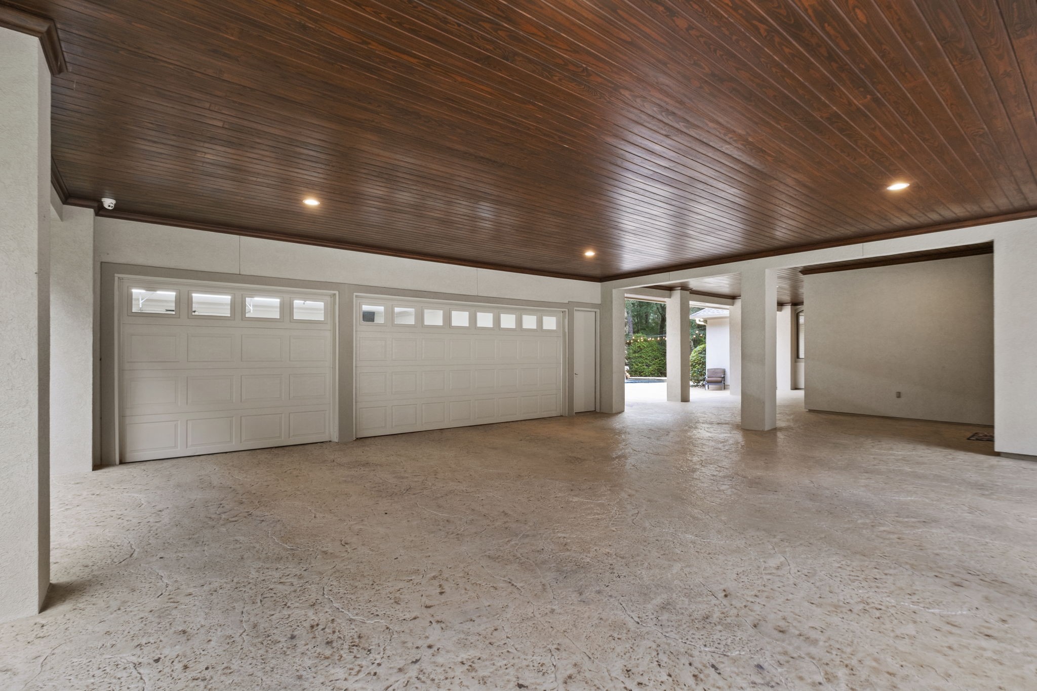 20010 Timber Ridge Drive Magnolia, TX 77355 - Photo 38 of 50 This expansive 912 sq ft carport offers exceptional, lighted, covered parking just steps from the garage, providing both convenience and protection from the elements. With ample space for multiple vehicles, equipment, or recreational toys, it’s a practical extension of the home’s functionality.