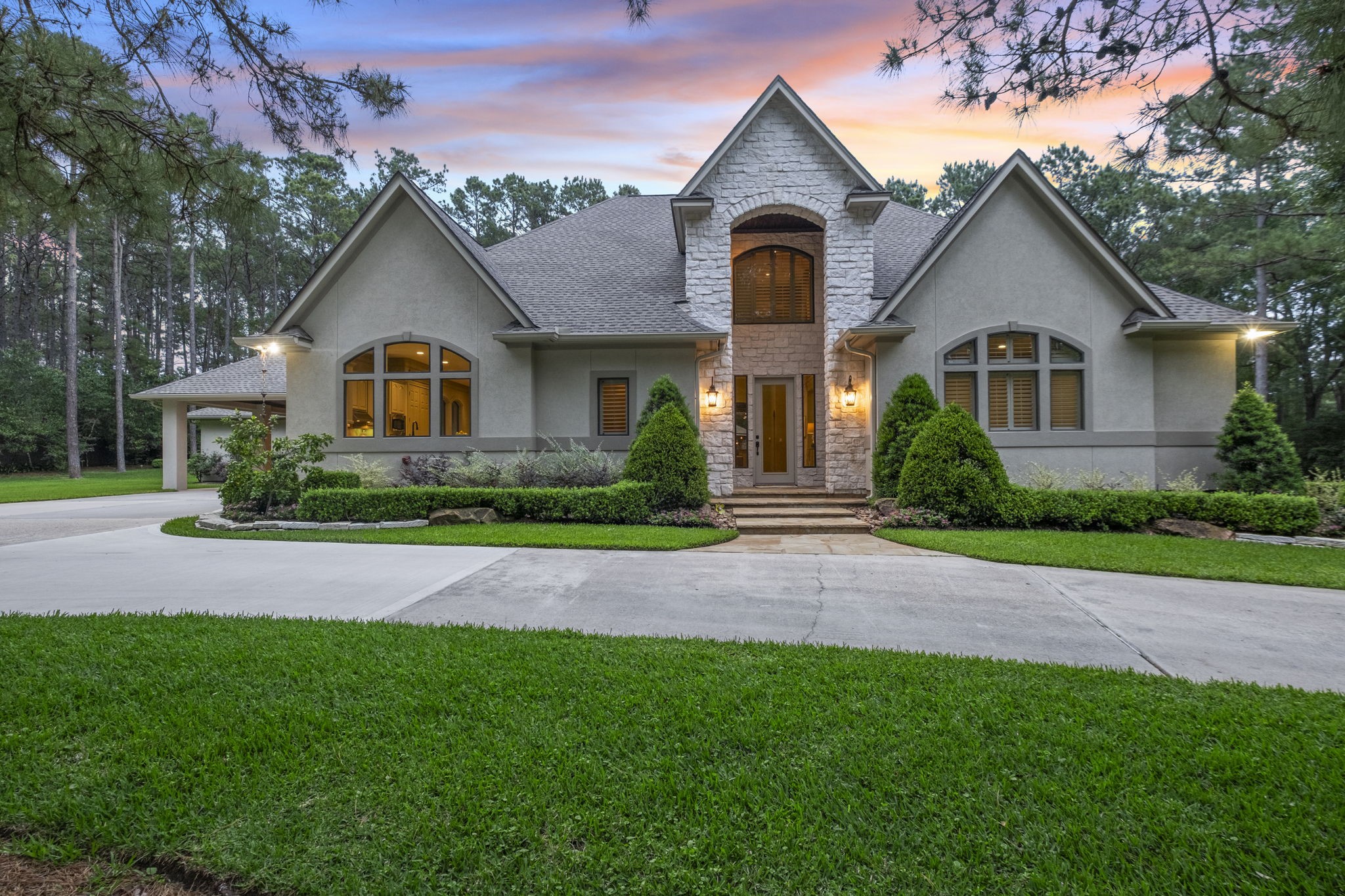 20010 Timber Ridge Drive Magnolia, TX 77355 - Photo 4 of 50 Tucked away at the end of the private driveway, this striking 3650 sqft home makes a memorable first impression. Framed by mature trees and thoughtfully designed landscaping, the approach feels both private and grand.