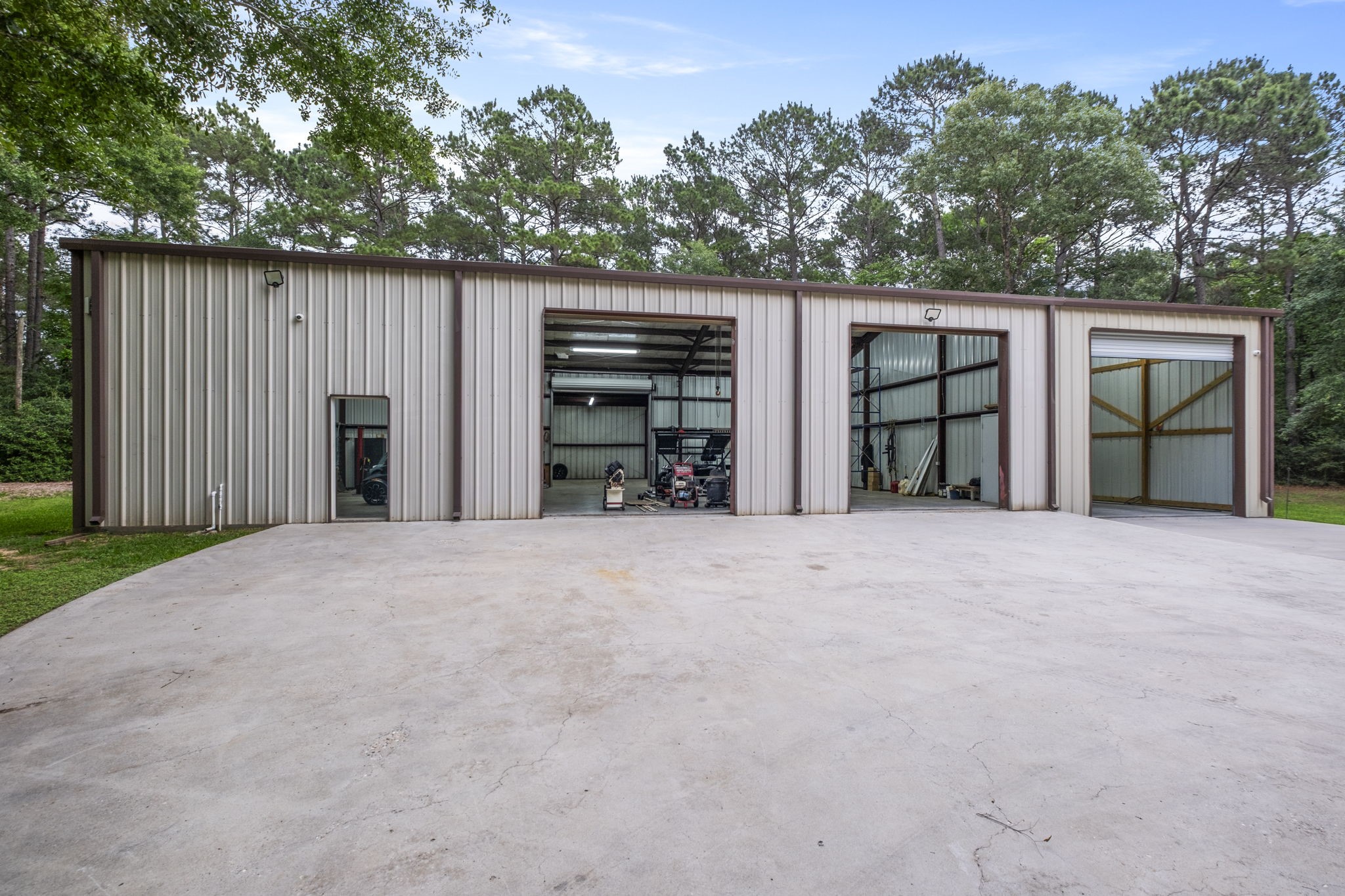 20010 Timber Ridge Drive Magnolia, TX 77355 - Photo 43 of 50 This impressive approximately 5,700 sq ft workshop offers an exceptional space designed to handle projects of any scale. Equipped with electrical throughout, it provides the power and flexibility needed for tools, equipment, and specialized work. The 3rd bay on the right is perfect for housing your RV and has a 50 amp service.