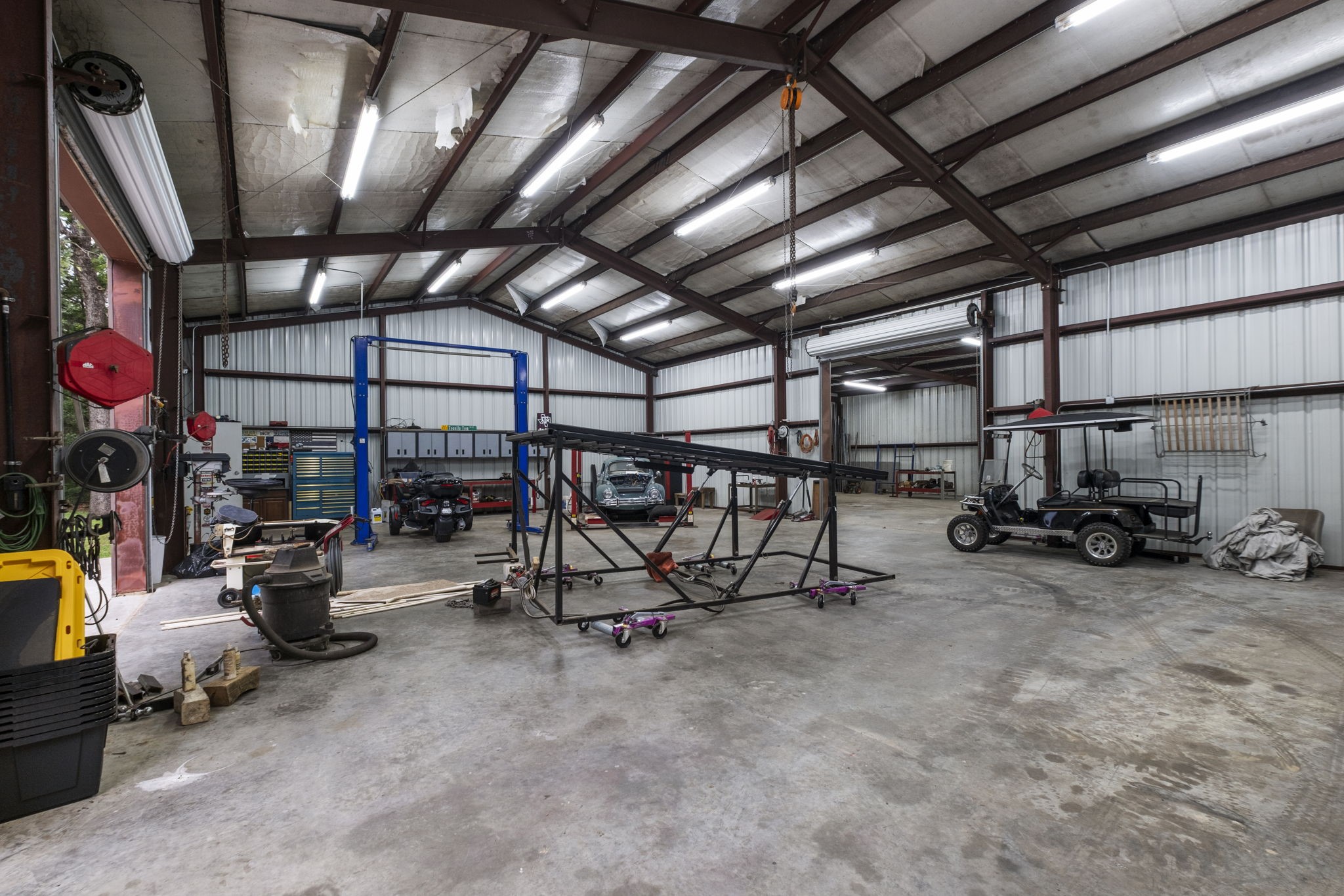 20010 Timber Ridge Drive Magnolia, TX 77355 - Photo 44 of 50 This spacious metal workshop features high ceilings, ample lighting, and large garage doors, ideal for automotive projects or storage. The two car lifts are negotiable.