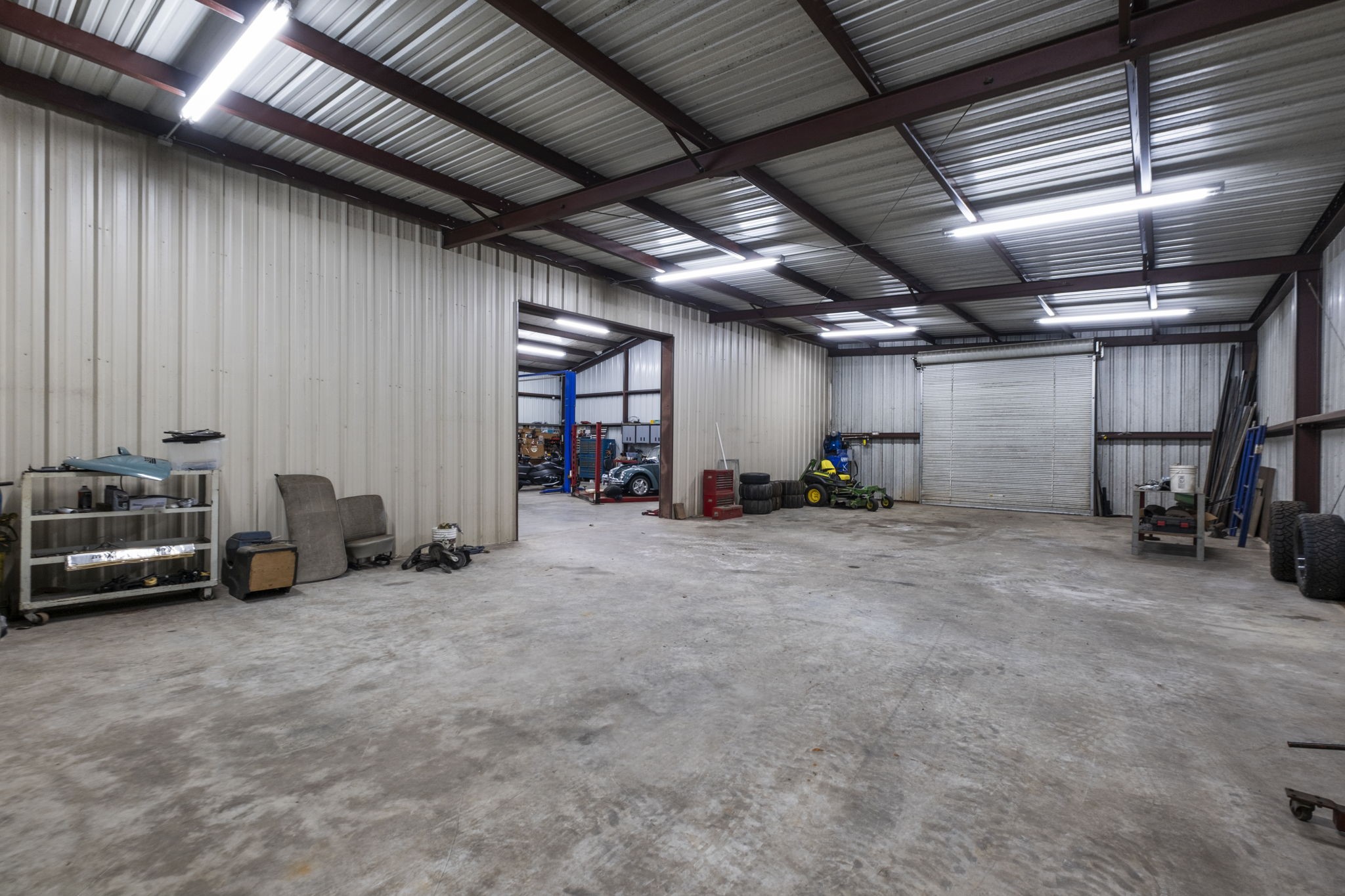 20010 Timber Ridge Drive Magnolia, TX 77355 - Photo 45 of 50 The expansive interior allows for multiple workstations, storage, or even business operations, all within a well-designed, highly functional layout. Whether you’re a craftsman, hobbyist, or entrepreneur, this versatile workshop delivers the space and capability to bring your vision to life.