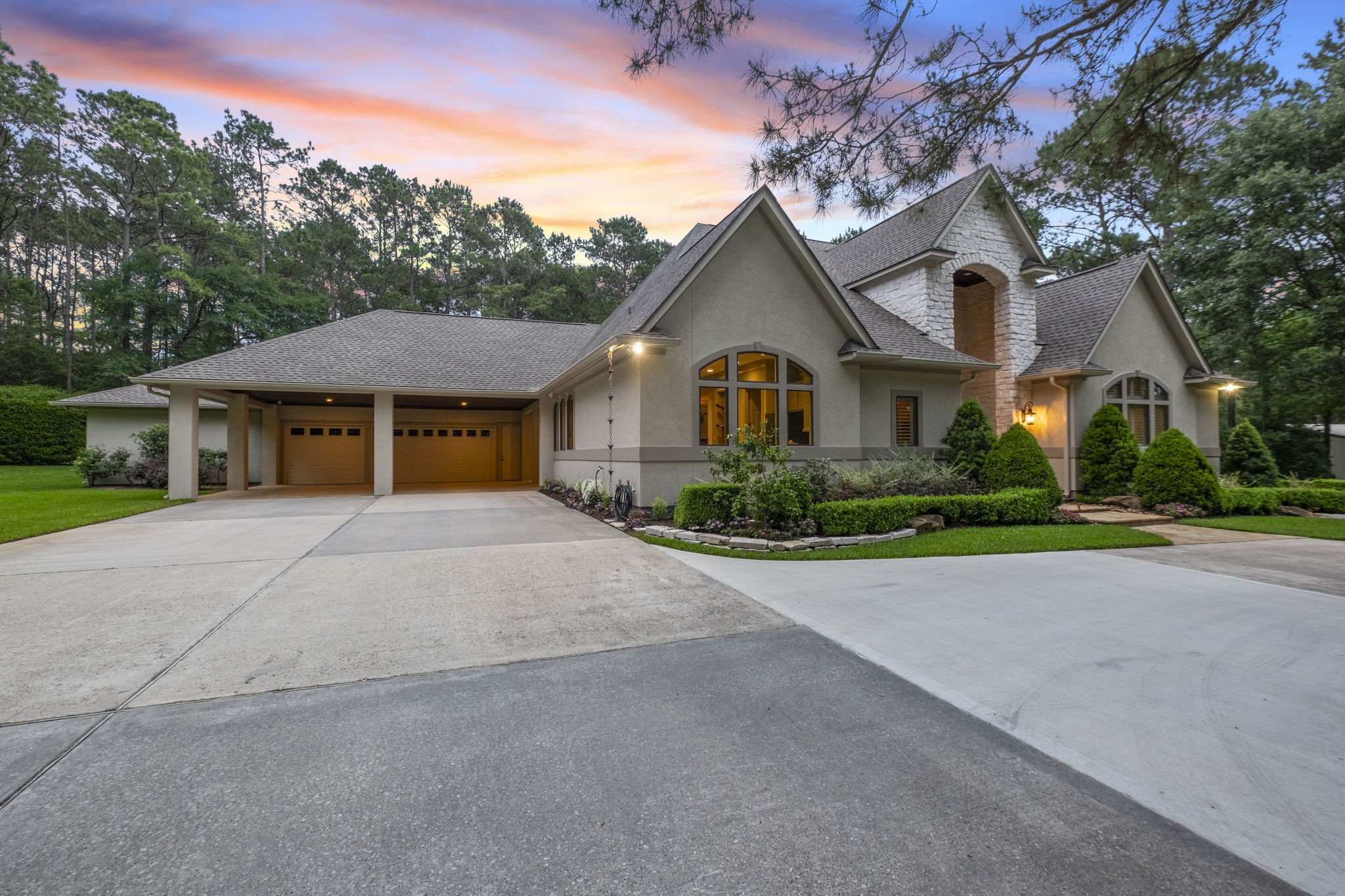 20010 Timber Ridge Drive Magnolia, TX 77355 - Photo 6 of 50 Completing the property is an attached, 2101 sqft, 9-car garage along with a spacious 912 sqft carport, offering exceptional parking, storage, and convenience without compromising the home’s elegant curb appeal.