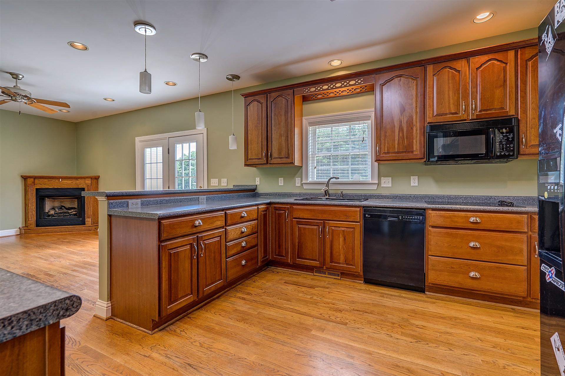 340 Mallard Point Road Wirtz, VA 24184 - Photo 14 of 41 a kitchen with stainless steel appliances granite countertop wooden cabinets a sink and dishwasher