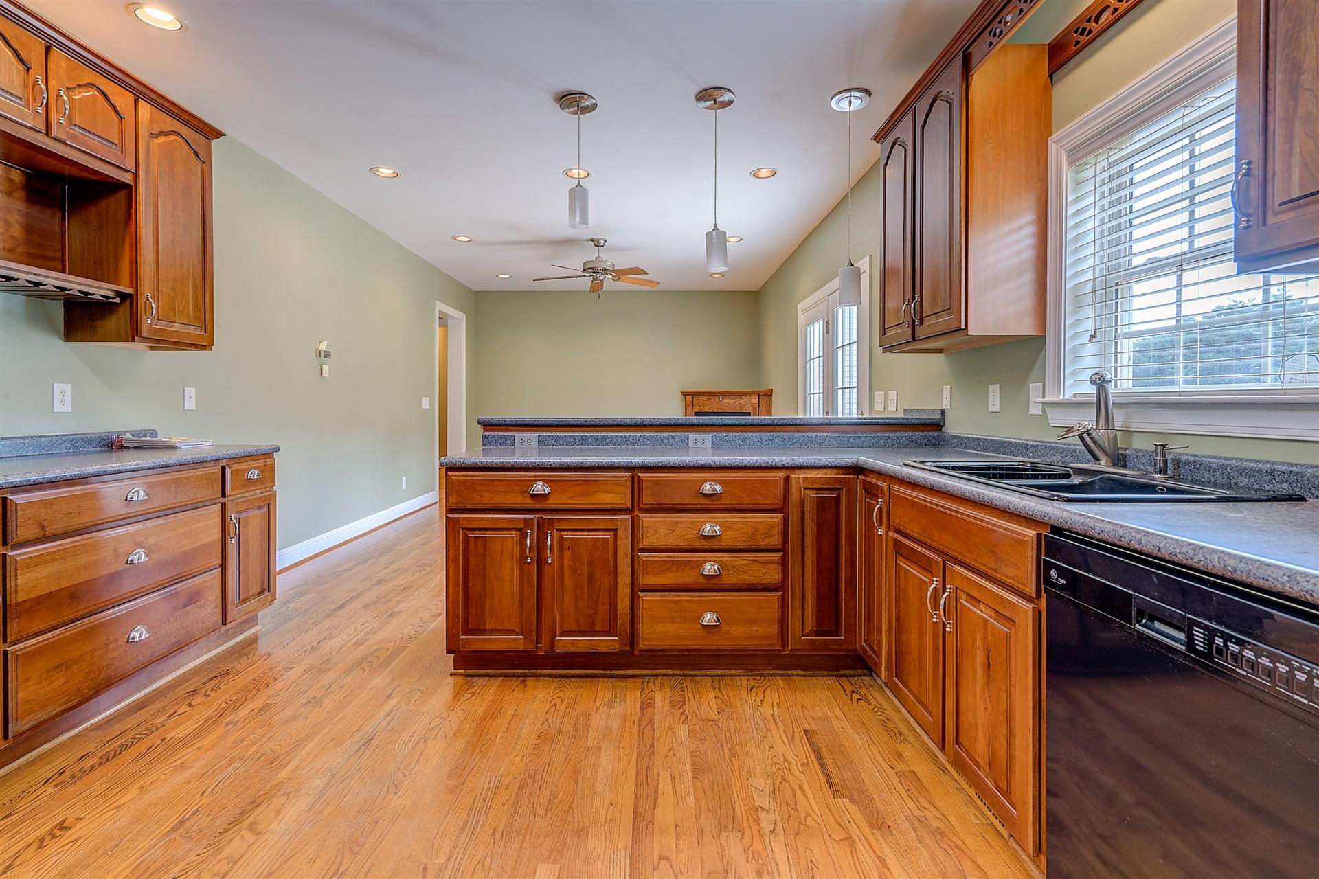 340 Mallard Point Road Wirtz, VA 24184 - Photo 16 of 41 a kitchen with stainless steel appliances granite countertop a sink a stove and a wooden floors