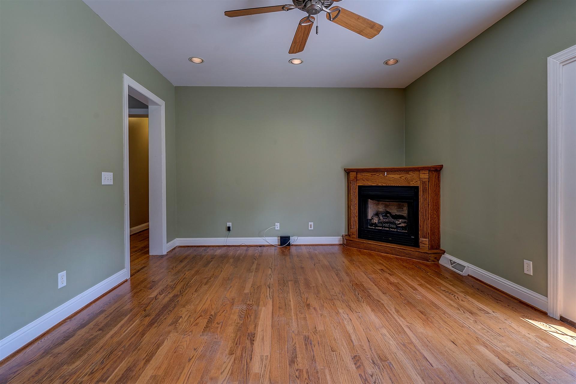 340 Mallard Point Road Wirtz, VA 24184 - Photo 19 of 41 an empty room with wooden floor and fireplace