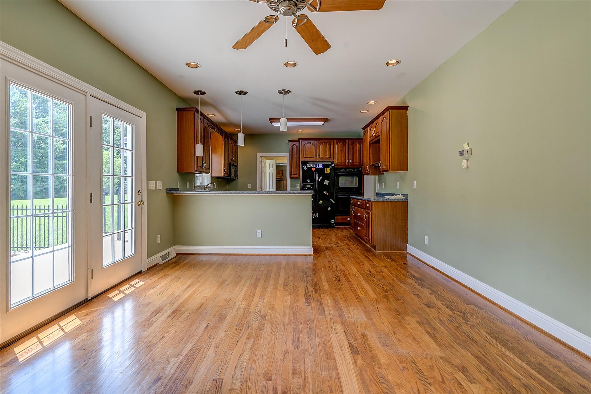 340 Mallard Point Road Wirtz, VA 24184 - Photo 21 of 41 a view of a livingroom with furniture wooden floor a ceiling fan and windows