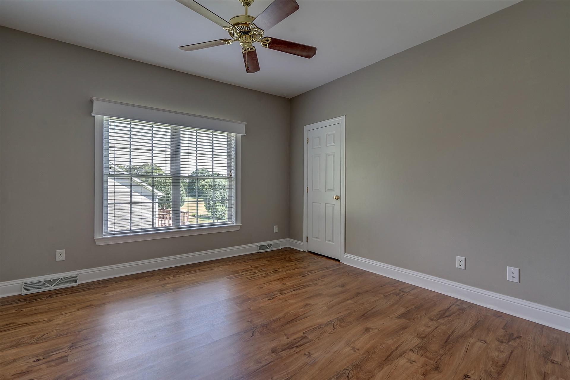 340 Mallard Point Road Wirtz, VA 24184 - Photo 28 of 41 an empty room with wooden floor chandelier fan and windows