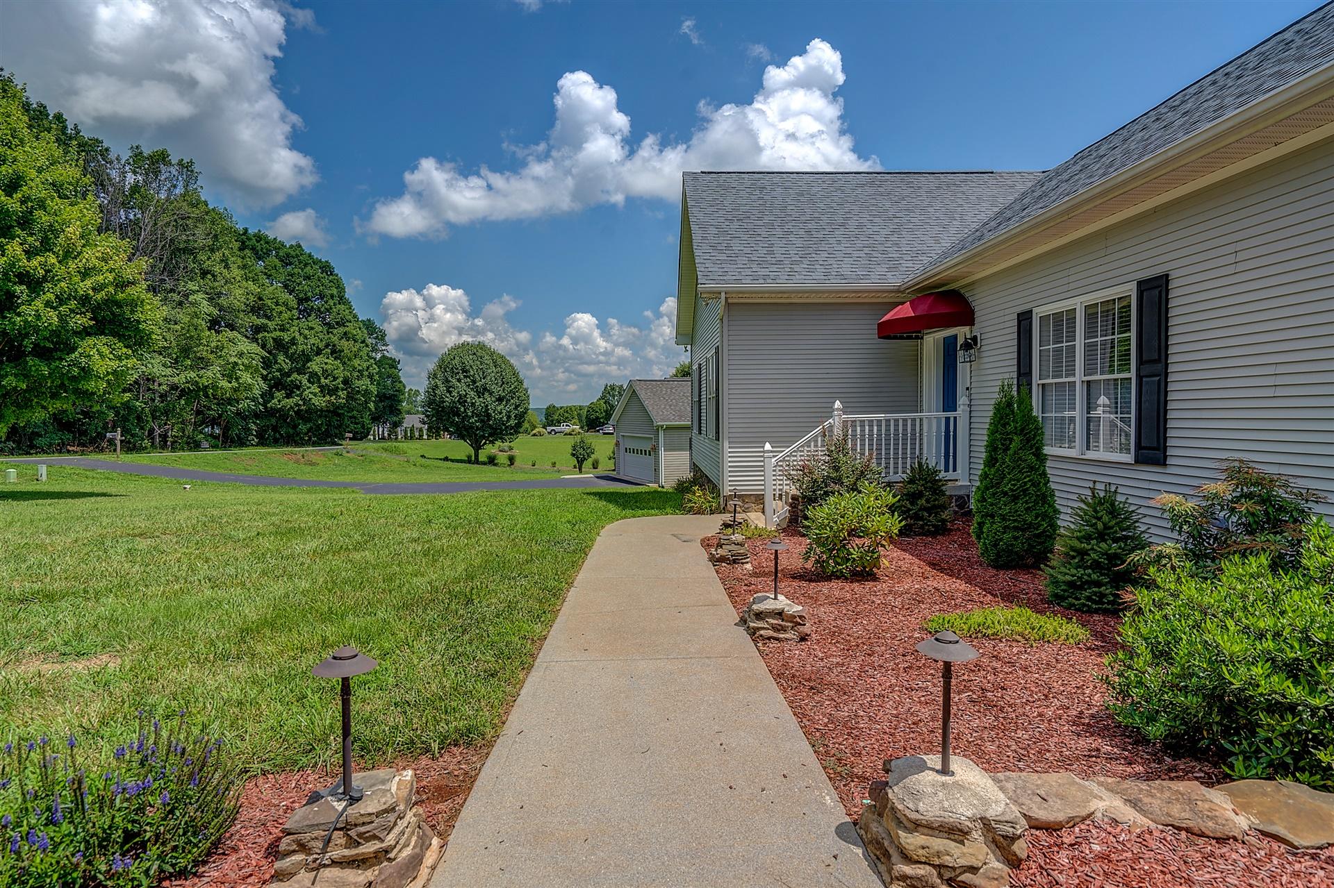 340 Mallard Point Road Wirtz, VA 24184 - Photo 5 of 41 a front view of a house with a yard and potted plants