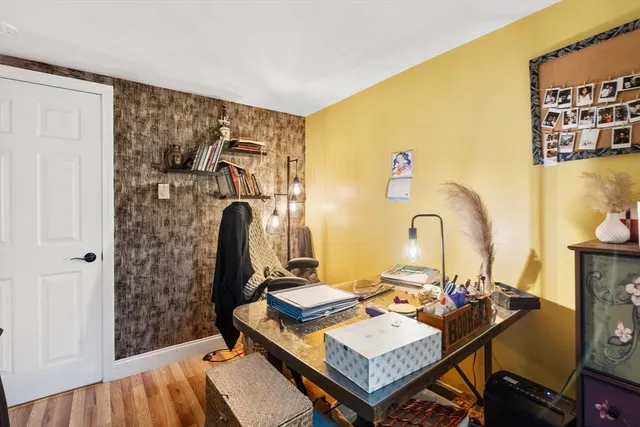a view of a workspace with furniture and wooden floor