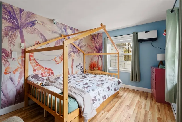 a living room with furniture a rug and gym equipment