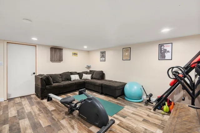 a living room with furniture a flat screen tv and a window