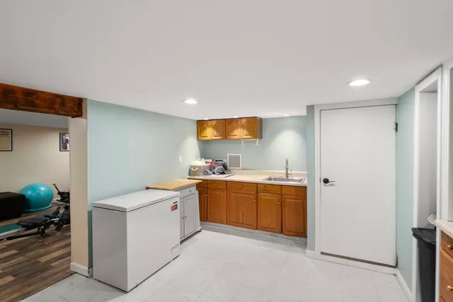 a spacious bedroom with a bed and a chair in it