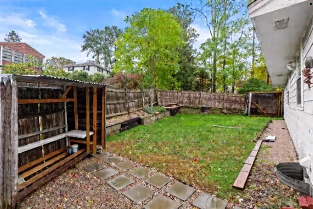a view of a house with backyard and sitting area