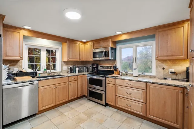 a kitchen with appliances cabinets and furniture
