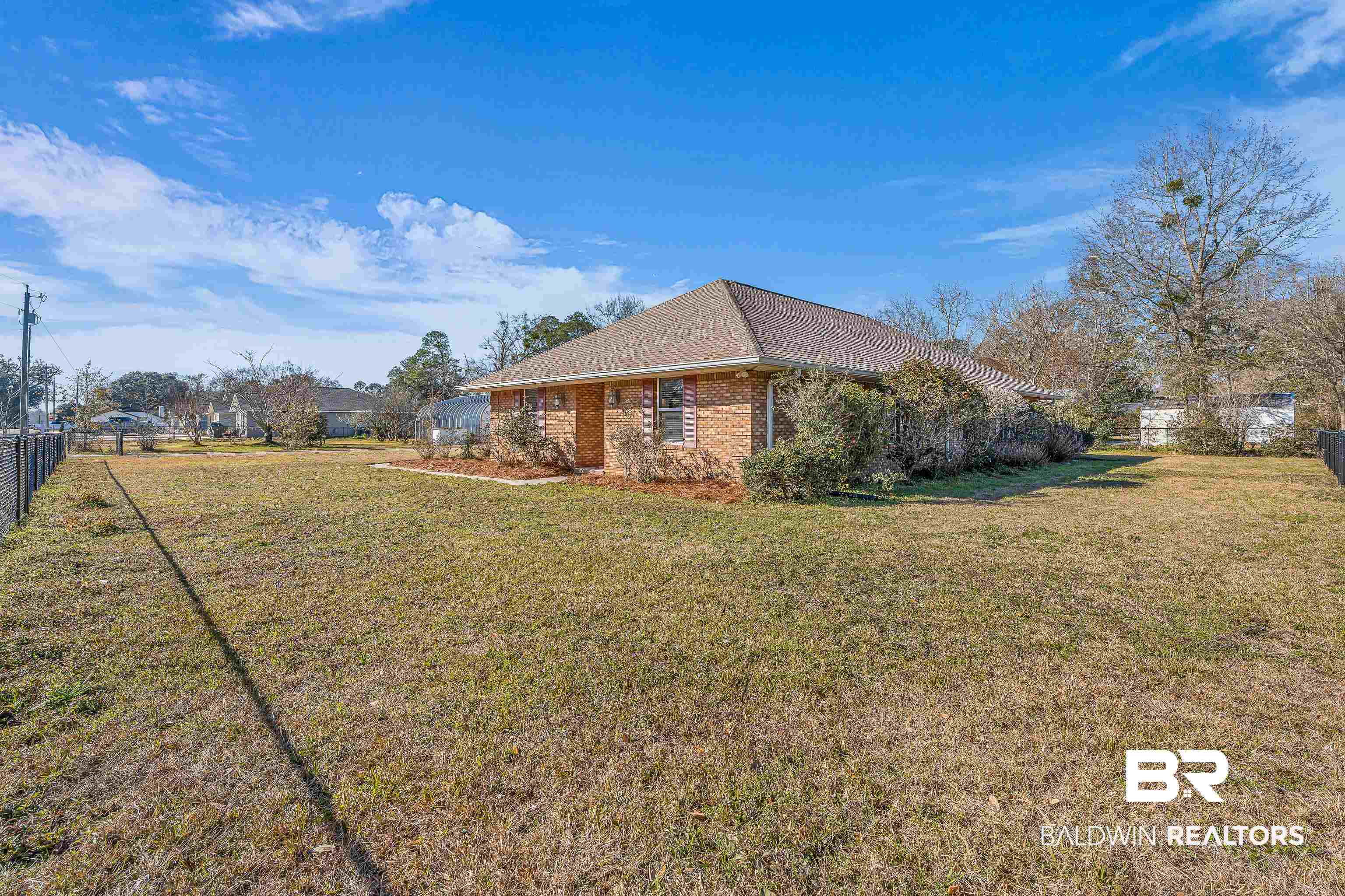 22095 8th Street Silverhill, AL 36576 - Photo 9 of 42 View of home's exterior featuring brick siding and a shingled roof