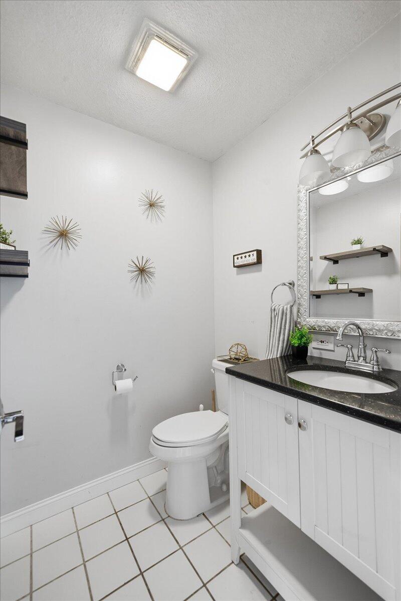 426 Laurel Lane Valparaiso, IN 46385 - Photo 31 of 48 a bathroom with a granite countertop sink a toilet and a mirror