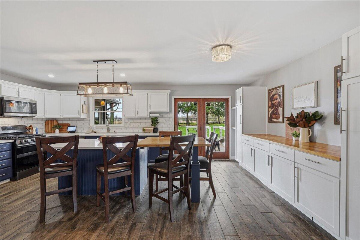 426 Laurel Lane Valparaiso, IN 46385 - Photo 6 of 48 a large kitchen with a table and chairs