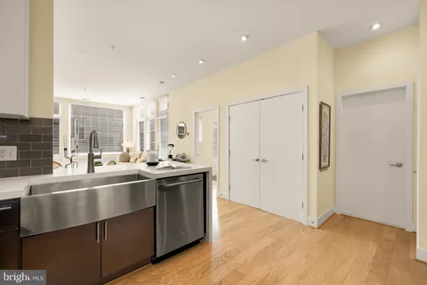 a kitchen with stainless steel appliances granite countertop a sink and a refrigerator