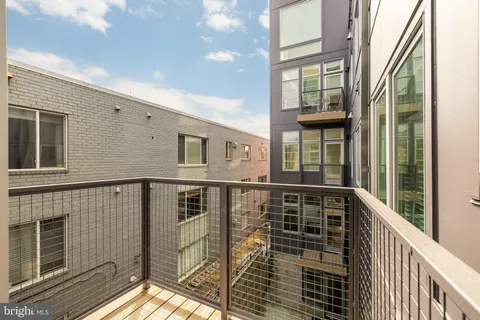 a view of a balcony with wooden floor and fence