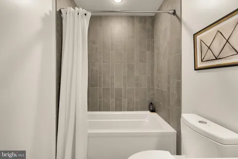 a bathroom with a shower and a toilet