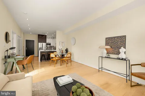 a living room with furniture a dining table and kitchen view