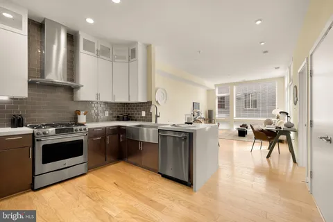 a kitchen with a sink stove and white cabinets