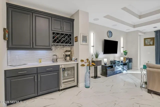 a kitchen with stainless steel appliances a sink cabinets and wooden floor