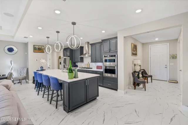 a living room with furniture a chandelier and a flat screen tv