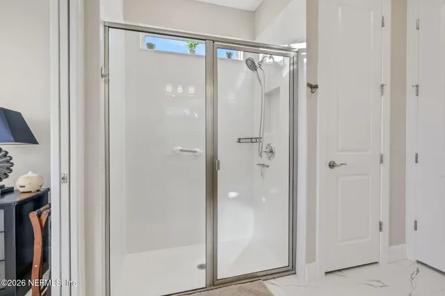 a view of a dining room with furniture large windows and wooden floor