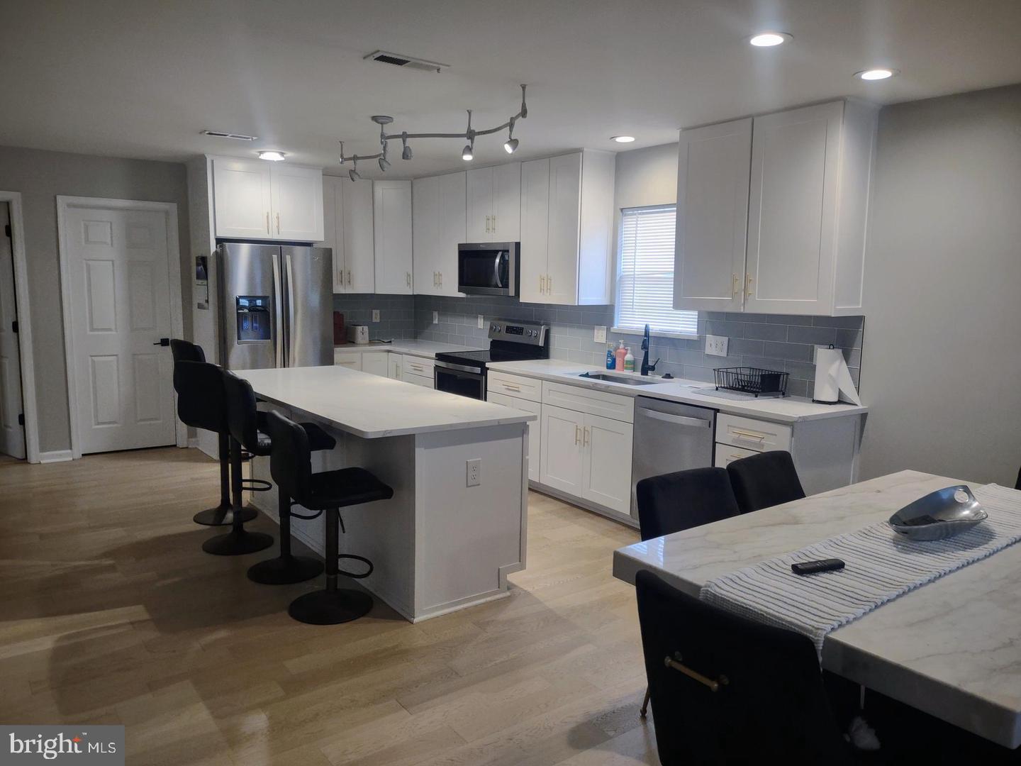 206 Decatur Street Berlin, MD 21811 - Photo 3 of 4 a kitchen with a sink a counter top space stainless steel appliances and cabinets