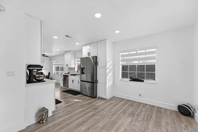 a kitchen with stainless steel appliances a refrigerator and a stove top oven