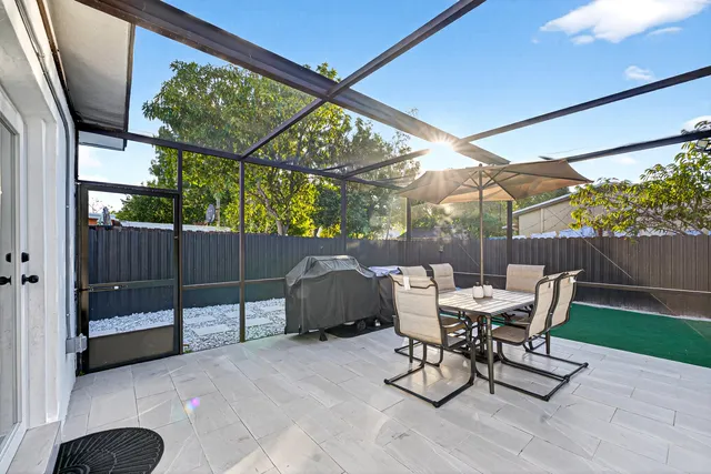 a view of a patio with a table and chairs