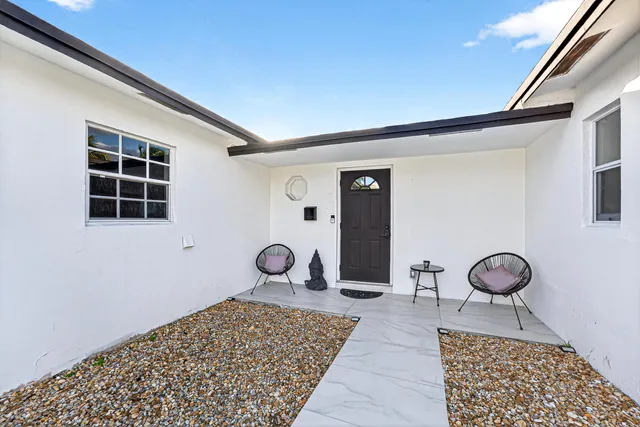 a area with wooden floor and clock on the wall