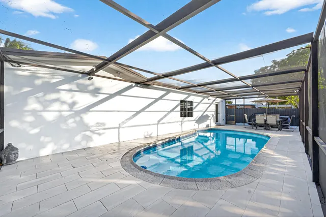 a view of a swimming pool with a patio