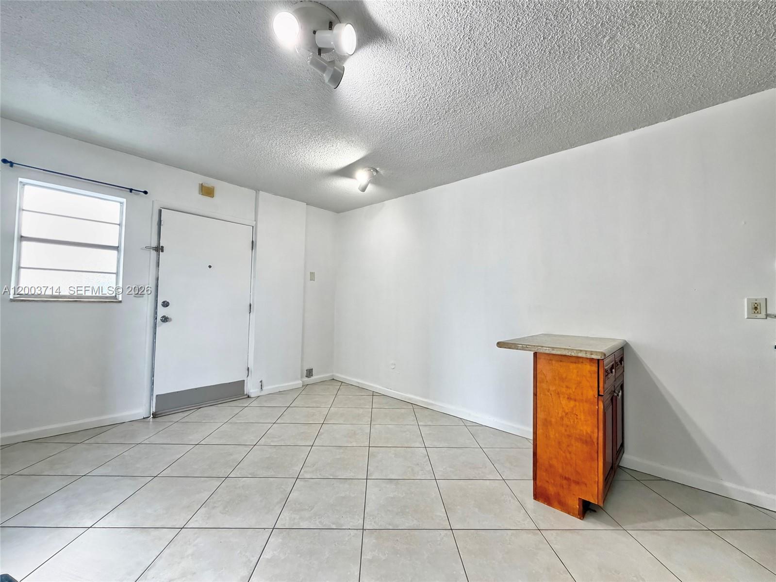 1340 Lincoln Road, Unit 709 Miami Beach, FL 33139 - Photo 5 of 13 an empty room with windows