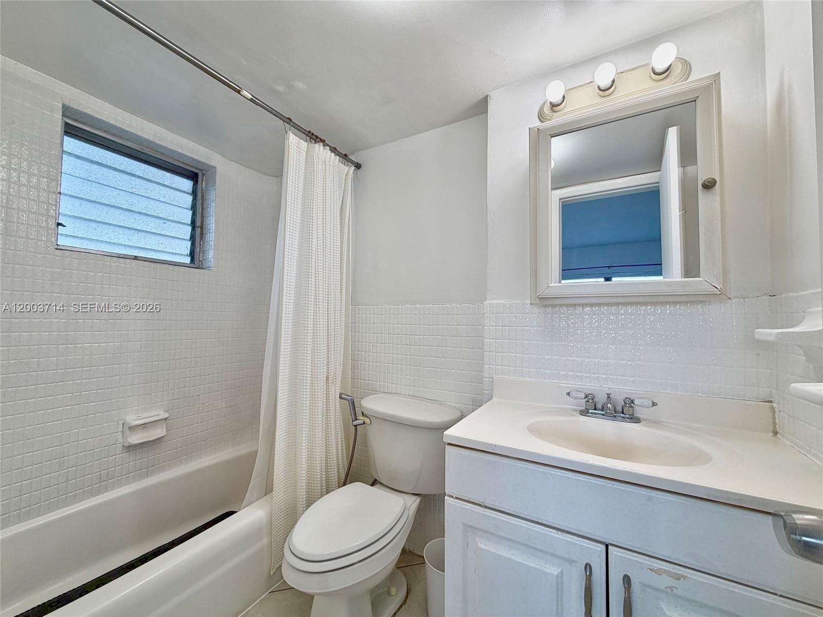 1340 Lincoln Road, Unit 709 Miami Beach, FL 33139 - Photo 8 of 13 a bathroom with a sink toilet and shower